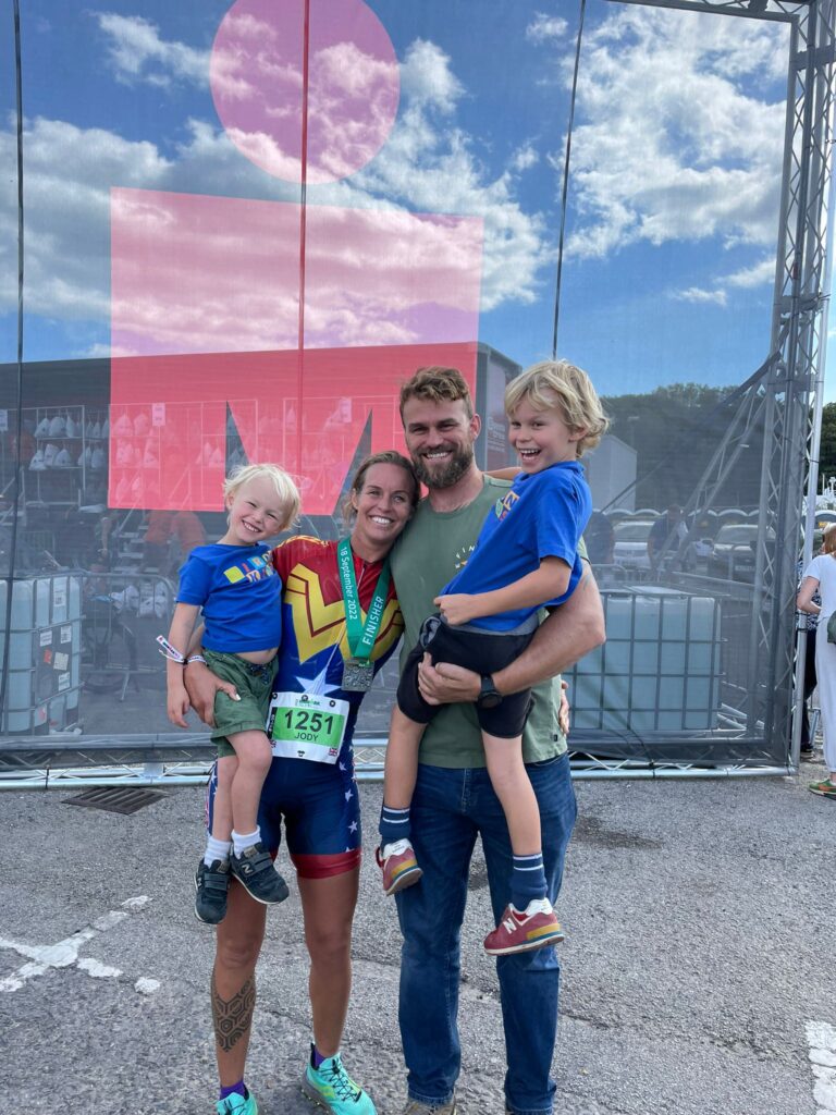 Photo of Jody Smith with her family after completing the Half IronMan in Weymouth 2022